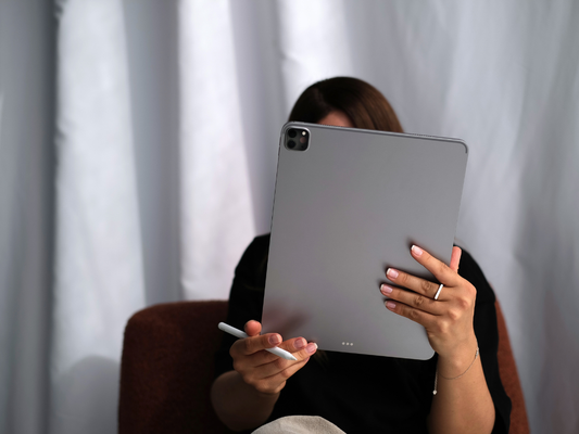 Woman holding a tablet in front of her face